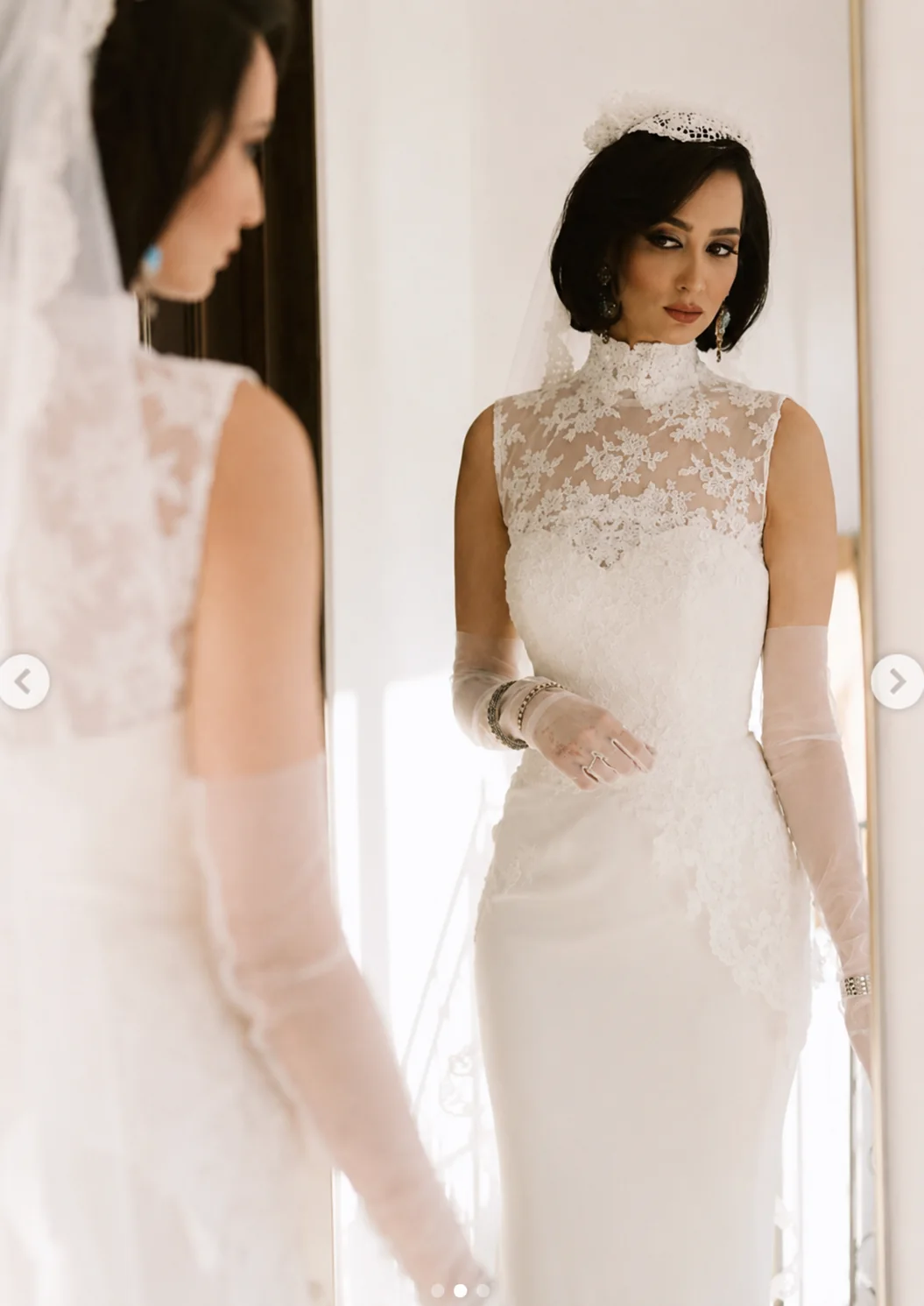 A client wearing an ivory high-neck lace gown